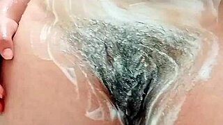 young brunette shaves her hairy pussy closeup in bathroom
