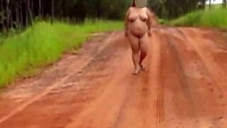 Pregnant Woman Stands Naked On Quiet Country Road