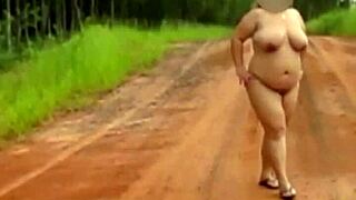 Pregnant Woman Stands Naked On Quiet Country Road