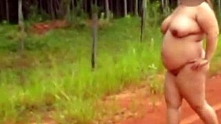 Pregnant Woman Stands Naked On Quiet Country Road