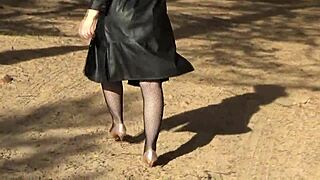 blonde walks confidently in fishnet bodystocking outfit