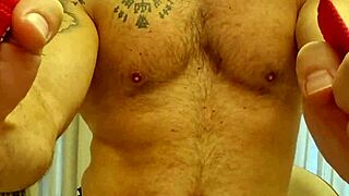 Muscular firefighter does gay striptease