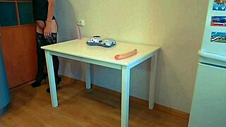 milf stretches ass with dildo on table