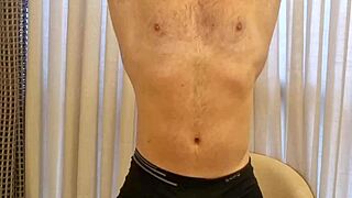 Muscular firefighter does gay striptease