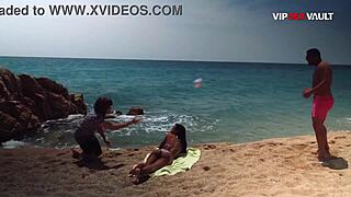 Oiled ebony babe gets rubbed on a public beach